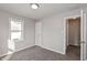 Well-lit bedroom with gray walls, plush carpeting, and a window offering natural light at 518 E College Ave, Brownsburg, IN 46112