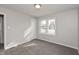 Bright bedroom featuring neutral walls, plush carpeting, and a window with natural light at 518 E College Ave, Brownsburg, IN 46112