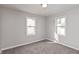 A bright bedroom features fresh gray paint and two windows providing ample natural light at 518 E College Ave, Brownsburg, IN 46112