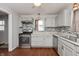 Modern kitchen featuring stainless steel appliances, light gray cabinets and elegant backsplash at 518 E College Ave, Brownsburg, IN 46112