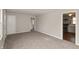 Spacious living room with neutral paint, carpet, and multiple doorways at 518 E College Ave, Brownsburg, IN 46112