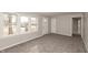 Bright living room with multiple windows and neutral carpet at 518 E College Ave, Brownsburg, IN 46112