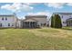 Grassy backyard showing enclosed sunroom and lawn between houses at 5546 W Vistaview Trl, McCordsville, IN 46055