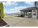 Backyard with a concrete patio, lawn, and view of the pond at 5546 W Vistaview Trl, McCordsville, IN 46055