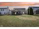 Expansive backyard featuring a well-maintained lawn and a screened-in porch for outdoor enjoyment at 5546 W Vistaview Trl, McCordsville, IN 46055