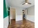 Bedroom featuring mountain mural, hardwood floors, white wainscoting, closet, and doorway at 5546 W Vistaview Trl, McCordsville, IN 46055