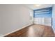 Bedroom featuring hard wood floors, natural light window, blue accent wall with white built-in shelving at 5546 W Vistaview Trl, McCordsville, IN 46055