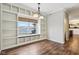 Dining area with built-in shelving, a lake view, and modern light fixture at 5546 W Vistaview Trl, McCordsville, IN 46055