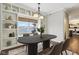 Dining area featuring built-in shelving, lake views, and modern furniture at 5546 W Vistaview Trl, McCordsville, IN 46055