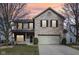 Two-story brick home with a two-car garage and a well-manicured lawn at sunset at 5546 W Vistaview Trl, McCordsville, IN 46055