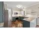 Bright kitchen with stainless steel appliances, granite counters, white cabinets, and dark wood floors at 5546 W Vistaview Trl, McCordsville, IN 46055