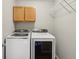 Laundry room with white washer and dryer, overhead cabinets, and wire rack at 5546 W Vistaview Trl, McCordsville, IN 46055