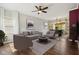 Stylishly staged living room with neutral furniture, area rug and an adjacent dining space at 5546 W Vistaview Trl, McCordsville, IN 46055