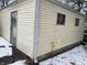 Showing deferred maintenance on the exterior of a detached garage with snow on the ground at 5834 42Nd St, Indianapolis, IN 46226