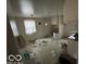 A distressed kitchen featuring sparse white cabinetry needing rehabilitation at 5834 42Nd St, Indianapolis, IN 46226