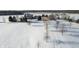 Expansive aerial view of a beautiful home and property covered in fresh snow on a sunny day at 5895 W 265 N, Columbus, IN 47201