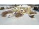 The sunroom and patio stand out in this winter aerial photo of the home's rear exterior at 5895 W 265 N, Columbus, IN 47201