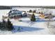 Attractive aerial view of a home with a barn, all blanketed in pristine snow at 5895 W 265 N, Columbus, IN 47201