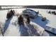Sweeping aerial view of a large home with a stone facade and surrounding snowy property at 5895 W 265 N, Columbus, IN 47201