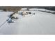 The home and outbuilding are surrounded by an impressive snow-covered property at 5895 W 265 N, Columbus, IN 47201