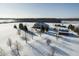 Wide aerial shot showcasing the lovely home and snowy landscape on a clear, bright day at 5895 W 265 N, Columbus, IN 47201