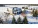A grand home with a porch and well-maintained landscaping under a blanket of winter snow at 5895 W 265 N, Columbus, IN 47201