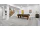 Finished basement featuring a pool table, wood staircase and neutral walls at 5895 W 265 N, Columbus, IN 47201
