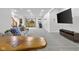Spacious basement featuring a plush gray couch, large screen television, and elegant wood table at 5895 W 265 N, Columbus, IN 47201