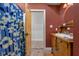 The bathroom features a decorative vanity with round mirror and a blue floral shower curtain at 5895 W 265 N, Columbus, IN 47201