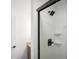 Walk-in shower with black trim glass, matte black shower head and handle and white shower surround at 5895 W 265 N, Columbus, IN 47201