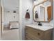 Bathroom featuring a modern vanity with a marble countertop and decorative mirror at 5895 W 265 N, Columbus, IN 47201