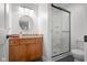This bathroom has wood cabinets, granite counters, a glass shower door, and modern fixtures at 5895 W 265 N, Columbus, IN 47201