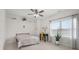Bright bedroom featuring a window with blinds, desk, and modern ceiling fan at 5895 W 265 N, Columbus, IN 47201
