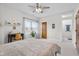 Bright bedroom featuring a desk, blinds on the window, and modern ceiling fan at 5895 W 265 N, Columbus, IN 47201