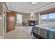 Serene bedroom featuring fireplace, tray ceiling, and picturesque views of the outdoors at 5895 W 265 N, Columbus, IN 47201