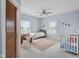 Bright bedroom with a rocking horse, crib and an upholstered chair at 5895 W 265 N, Columbus, IN 47201