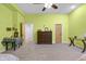 This spacious bedroom features lime green walls, neutral carpeting, and a ceiling fan at 5895 W 265 N, Columbus, IN 47201