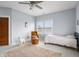 Bright bedroom featuring a cozy chair, patterned rug, and abundant natural light at 5895 W 265 N, Columbus, IN 47201