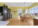 Bright dining room with hardwood floors and natural light coming from a large bank of windows at 5895 W 265 N, Columbus, IN 47201