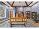 Elegant dining room showcases hardwood floors, a large table, a bench and custom trim details at 5895 W 265 N, Columbus, IN 47201