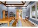 Elegant dining room features wood floors, a large table, and a modern sliding barn door at 5895 W 265 N, Columbus, IN 47201