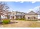 Stunning stone and siding home featuring a welcoming front porch and beautifully landscaped grounds at 5895 W 265 N, Columbus, IN 47201