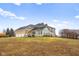 Large 2-story home with stone and vinyl siding, 3 car garage, large windows and open backyard at 5895 W 265 N, Columbus, IN 47201