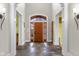 Elegant foyer featuring a wooden front door, slate floors, and tasteful wall decor at 5895 W 265 N, Columbus, IN 47201