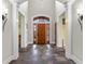 Elegant foyer featuring a wooden front door, slate floors, and tasteful wall decor at 5895 W 265 N, Columbus, IN 47201