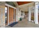 Inviting front porch with stone columns and a relaxing swing, ideal for enjoying the outdoors at 5895 W 265 N, Columbus, IN 47201