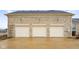 Three car garage with stone facade and outdoor wall lighting at 5895 W 265 N, Columbus, IN 47201