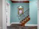 Inviting hallway with striking staircase, slate flooring, and unique wall decor at 5895 W 265 N, Columbus, IN 47201