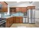 Bright kitchen with stainless steel appliances, wooden cabinets, granite countertops, and light blue backsplash at 5895 W 265 N, Columbus, IN 47201