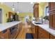 Open concept kitchen with stainless steel appliances, a large island, and views into the dining room at 5895 W 265 N, Columbus, IN 47201